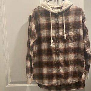 It’s a off-white and brown flannel shirt with the hoodie